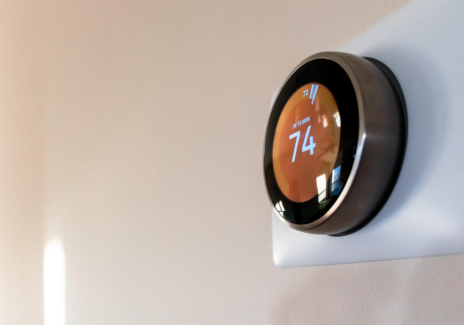 A smart thermostat is mounted on the wall.