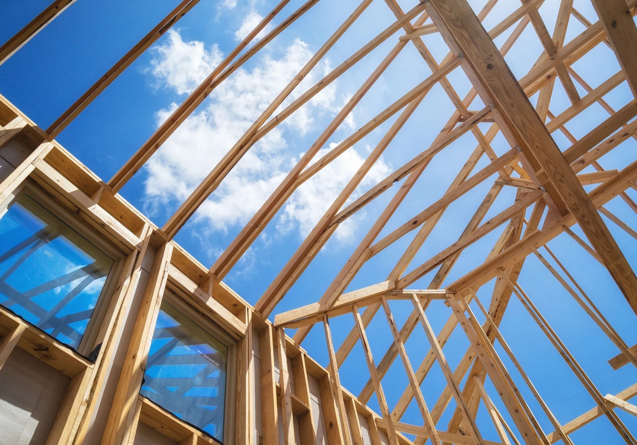 A wooden structure under construction with blue sky in the background.